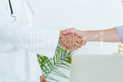 Doctor shaking hand of his patient