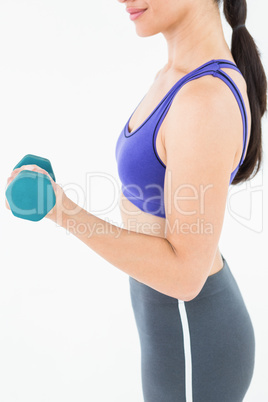 Fit woman lifting dumbbell