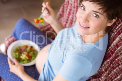 Pregnant woman eating a salad