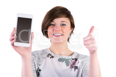 Pretty brunette holding her smartphone and looking at camera