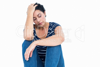 Unhappy woman sitting on the floor