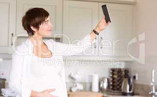 Pregnant woman taking a selfie