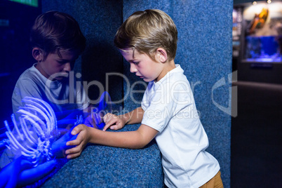 Young man touching an algae tank