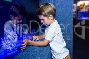 Young man touching an algae tank