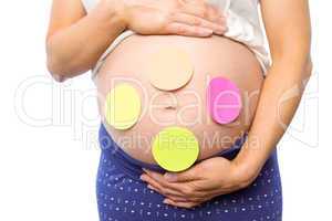 Pregnant woman with stickers on bump