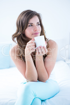 Thoughtful woman drinking a cup of coffee