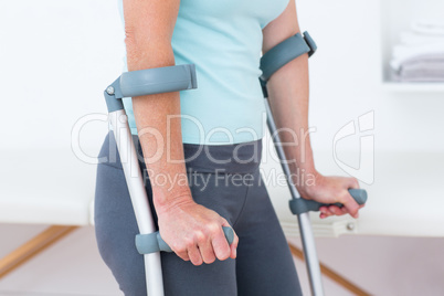 Woman standing with crutch