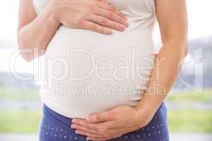 Pregnant woman holding her bump