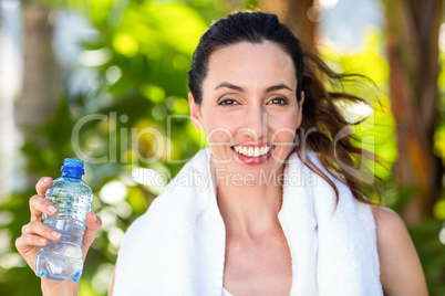 Beautiful brunette holding bottle of water