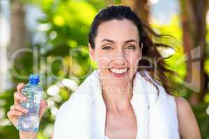 Beautiful brunette holding bottle of water