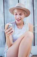 Pretty blonde woman texting with her mobile phone