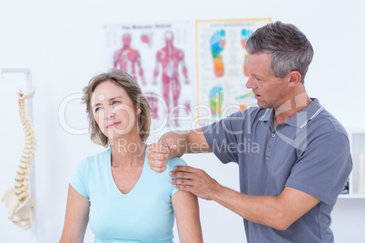 Doctor massaging his patient shoulders