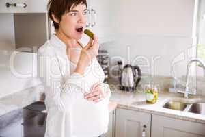 Pregnant woman eating a pickle