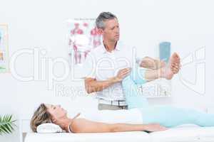 Doctor stretching his patients leg