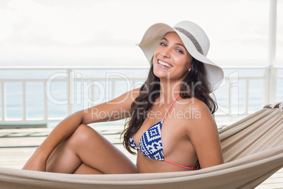 Pretty brunette relaxing on a hammock