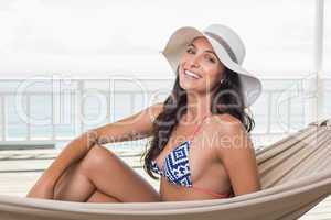 Pretty brunette relaxing on a hammock