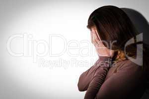 Depressed woman with head in hands