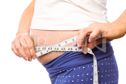 Pregnant woman measuring her bump