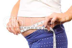 Pregnant woman measuring her bump