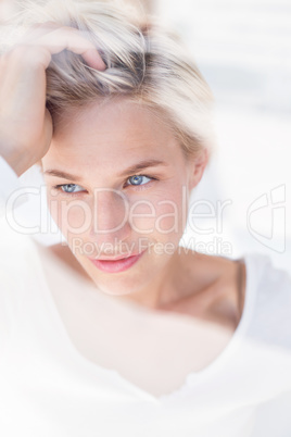 Thoughtful blonde woman looking through the window