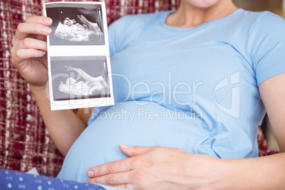 Pregnant woman looking at ultrasound scans