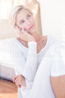 Smiling blonde woman calling on the phone