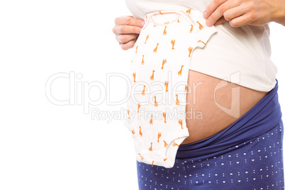 Pregnant woman holding baby clothes