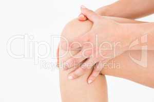 Natural woman touching her painful knee