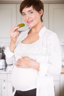 Pregnant woman eating jar of pickles