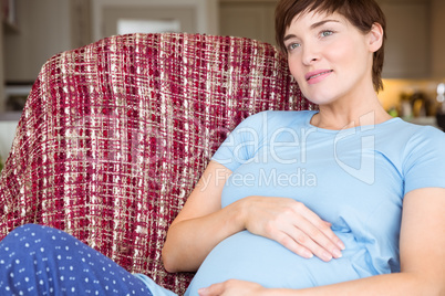 Pregnant woman relaxing on the couch