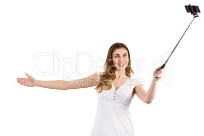 Pretty woman using a selfie stick