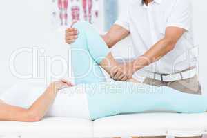 Doctor stretching his patients leg