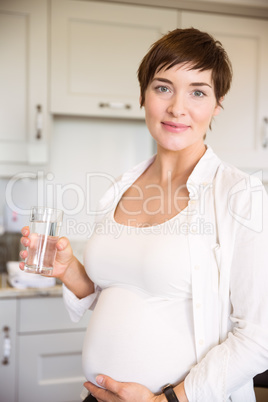 Pregnant woman having a glass of water