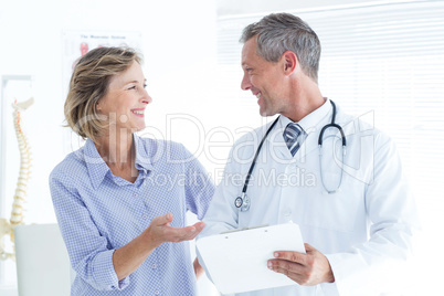 Doctor showing his notes to his patient