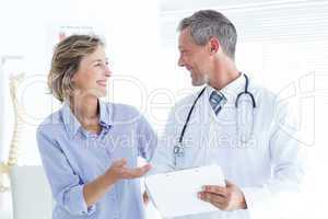 Doctor showing his notes to his patient