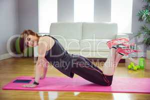 Fit woman doing press up on mat