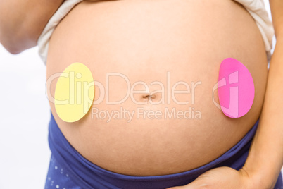 Pregnant woman with sticker on bump