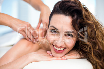 Smiling brunette getting back massage