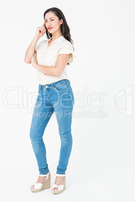 Thoughtful brunette standing hand on temple