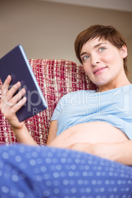 Pregnant woman using tablet pc Pregnant woman using tablet pc