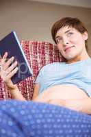 Pregnant woman using tablet pc