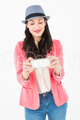 Elegant brunette holding her mobile phone