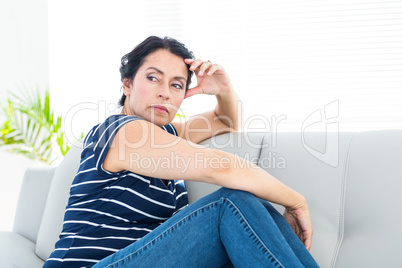 Unhappy woman sitting on the couch