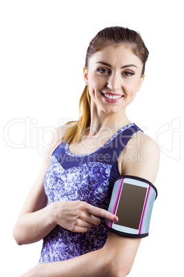 Fit woman using smartphone in armband