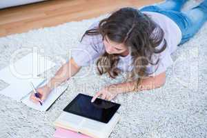 Pretty woman with books and tablet pc