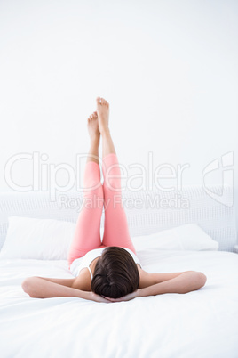 Peaceful woman relaxing in her bed