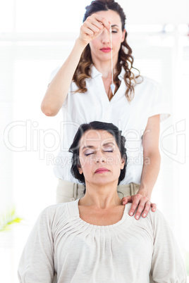 Therapist hypnotizing her patient