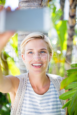 Pretty blonde woman taking selfie