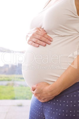 Pregnant woman holding her bump