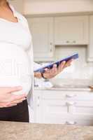 Pregnant woman using tablet pc